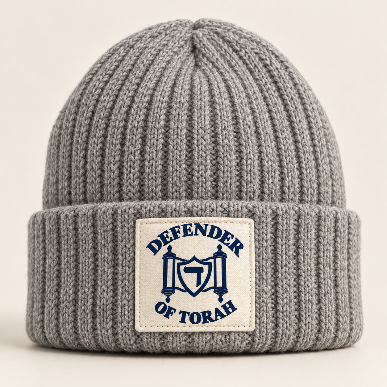 The Ribbed Beanie in heather gray / cream, with the Defender of Torah logo