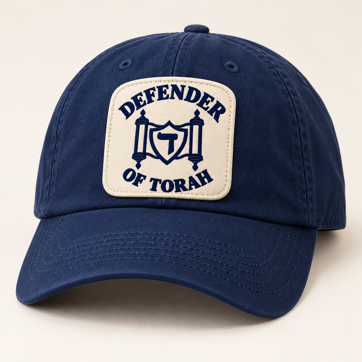 The Everyday Cap in navy / cream, with the Defender of Torah logo